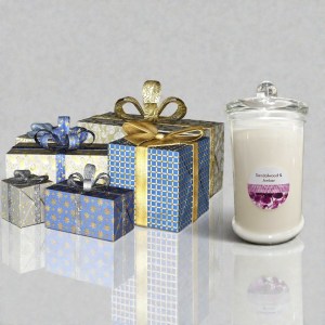 Handmade Sandalwood and Amber candle displayed beside decorative gift boxes, showcasing unique gift ideas from Vicki's Precious Petals in Muswellbrook NSW.
